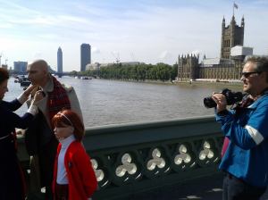 Filming on Westminster Bridge, London with our documentary cameraman, Stephen Reynolds setting up his next shot as Suzanne adjusts Chauncey's necktoe